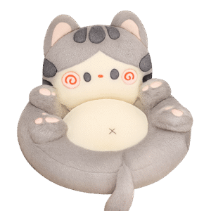 Cartoon-style plush cat cushion with gray body, pink cheeks, curled tail, and cream center pad.