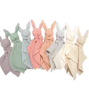 Pastel-colored baby bunny comforters with stitched eyes and long ears, arranged in a row on transparent background soft textured fabric ideal for newborn comfort and sleep.